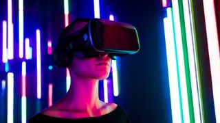 A woman wearing a virtual reality headset in a room full of colored lights